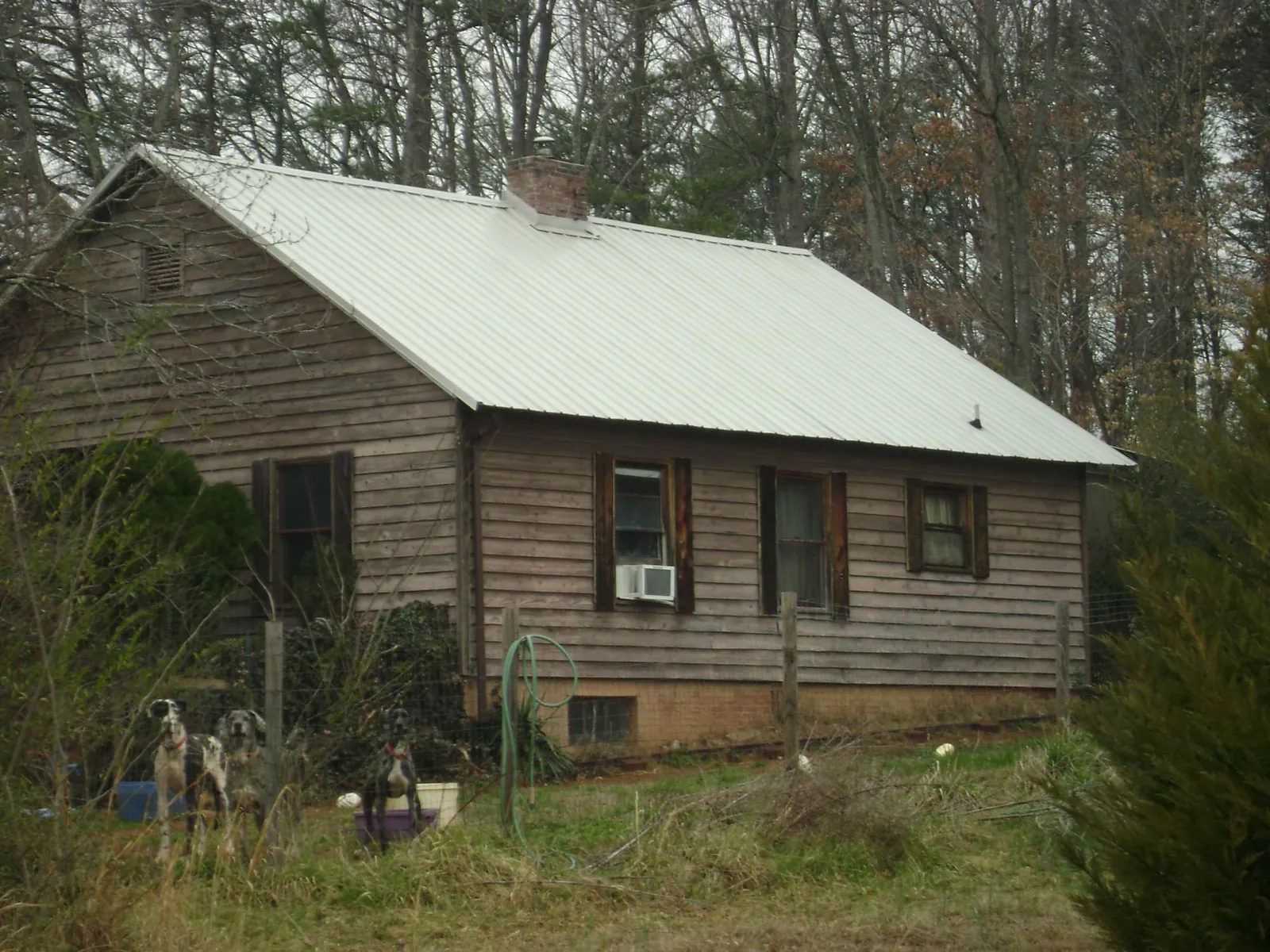 White metal roof on an old wood sided farmhouse, from a Metal Roof Installation job in Windber